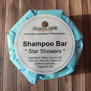 May include: A round, blue, paper-wrapped shampoo bar with a white label that reads "CELESTIAL FARMS JEFFERSON, OREGON www.etsy.com/shop/CFMerchantile Shampoo Bar * Star Showers * Ingredients: Water, Coconut Oil, Palm Oil, Olive Oil, Castor Oil, Sodium Hydroxide, Fragrance Oils."