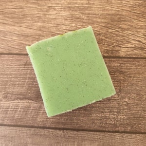 May include: A green bar of soap with a speckled texture.