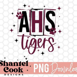 May include: AHS Tigers graphic with a distressed look. The letters are black with a maroon outline. The word "Tigers" is in maroon. There are paw prints and stars around the letters.