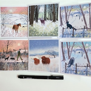 May include: Set of six winter-themed greeting cards featuring various scenes, including a horse in a snowy field, a black cat by a fence, a man walking with dogs, two Highland cattle in a field, and an owl perched on a fence.