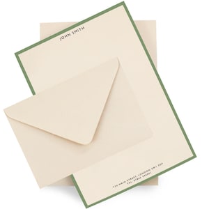May include: Cream-coloured stationery set with a green border. The set includes an envelope and notecards. The notecard has the name "JOHN SMITH" printed at the top. The address and phone number are printed at the bottom in black.