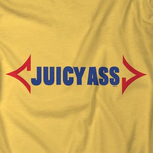 May include: A yellow t-shirt with a red and blue graphic that says "JUICY ASS" with arrows pointing in opposite directions.