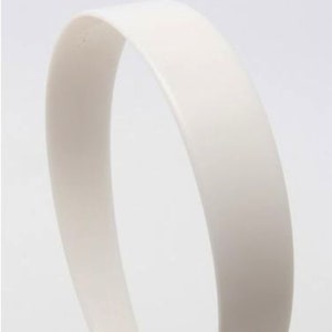 May include: A plain white plastic headband for hair.