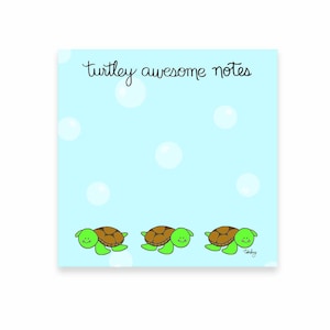 May include: A square notepad with a light blue background and white bubbles. The words "Turtley awesome notes" are written in black script. Three cartoon turtles with green bodies and brown shells are at the bottom.