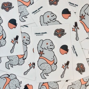 May include: A set of stickers featuring a cartoon manatee wearing a pink swimsuit and holding a starfish. The stickers also include a seashell, a fork, and the text "Cheeky" and "@ham_made_ ON INSTAGRAM".