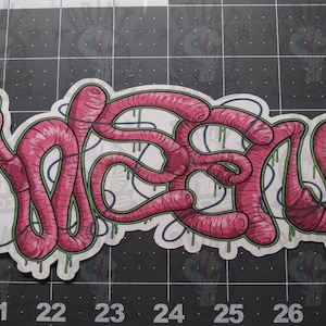 May include: A pink and green worm-shaped graphic design with the word "WORM" spelled out in a stylized font.