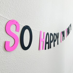 May include: Pink and black paper banner with the text "SO HAPPY I'M THIRTY".