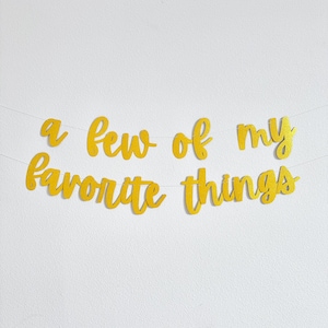 May include: A gold glitter banner that reads "a few of my favorite things".