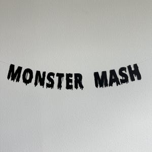 May include: Black and white banner with the text "Monster Mash" in dripping letters.