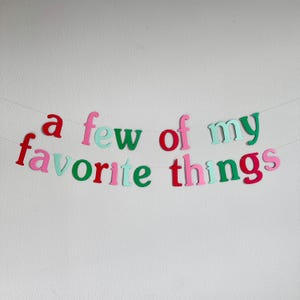 May include: A colorful paper banner with the phrase "a few of my favorite things" in green, red, pink, and blue letters.