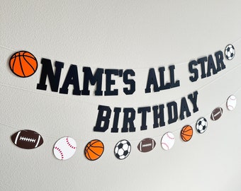 May include: A black and white sports themed banner with the text "NAME'S ALL STAR BIRTHDAY". The banner is decorated with orange basketballs, white baseballs, brown footballs, and black and white soccer balls.