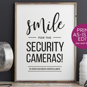 May include: Black and white sign with the text "smile for the security cameras! 24 hour recorded surveillance" and "print as-is or edit! (see next image)"