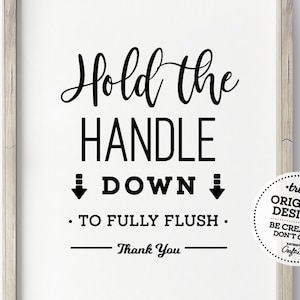 May include: Black and white sign with the text "Hold the Handle Down. To Fully Flush. Thank You."  The sign also includes a circle with the text "truly ORIGINAL DESIGNS BE CREATIVE DON'T COPY Craftie".