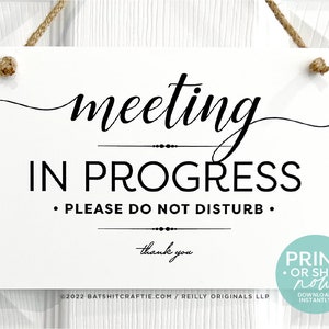 May include: White sign with black text that reads "meeting in progress. Please do not disturb. Thank you."  The sign is hanging from a string and has a small print or ship now! download instantly sticker in the bottom right corner.
