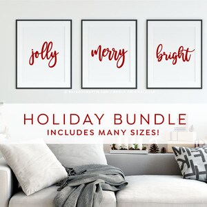 May include: Three framed prints with black frames and white mats. The prints feature the words "jolly", "merry", and "bright" in red cursive lettering. The text "HOLIDAY BUNDLE INCLUDES MANY SIZES!" is displayed below the prints.