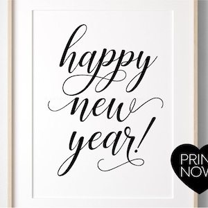 May include: Black and white printable art print with the text "happy new year!" in a cursive font. The text is centered on a white background. A black heart with the text "PRINT NOW!" is in the lower right corner.