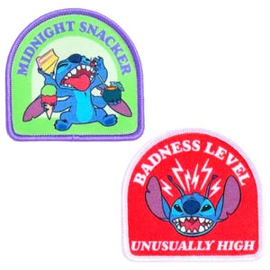 May include: Two embroidered patches featuring the character Stitch. One patch has Stitch with snacks and the text "MIDNIGHT SNACKER". The other patch has Stitch with lightning bolts and the text "BADNESS LEVEL UNUSUALLY HIGH".