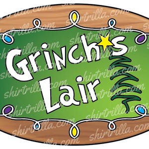 May include: A wooden oval sign with a green background and the text "Grinch's Lair" in white. The sign is decorated with a Christmas tree and colorful lights.