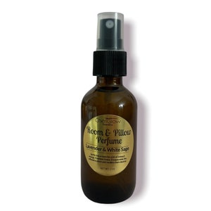 May include: A brown glass bottle with a gold label that reads "ChenGlow Cosmetics Room & Pillow Perfume Lavender & White Sage" and "Spritz into a room for a bit of tranquil energy. Freshens rooms. Encapsulates the offensive odours and renders them neutral. NET WT: 2.02 oz."