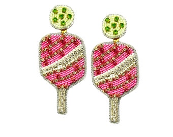 May include: A pair of pink and white beaded earrings shaped like popsicles with green beaded tops.