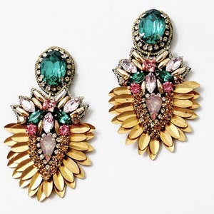 May include: Gold tone earrings with green and pink stones and gold leaf accents.