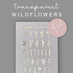 May include: A sheet of transparent wildflower stickers in various floral and leaf designs. The stickers are gold-colored and arranged on a white background. The words "transparent WILDFLOWERS" are written in cursive at the top.