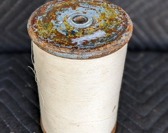 Vintage wooden spool with thread