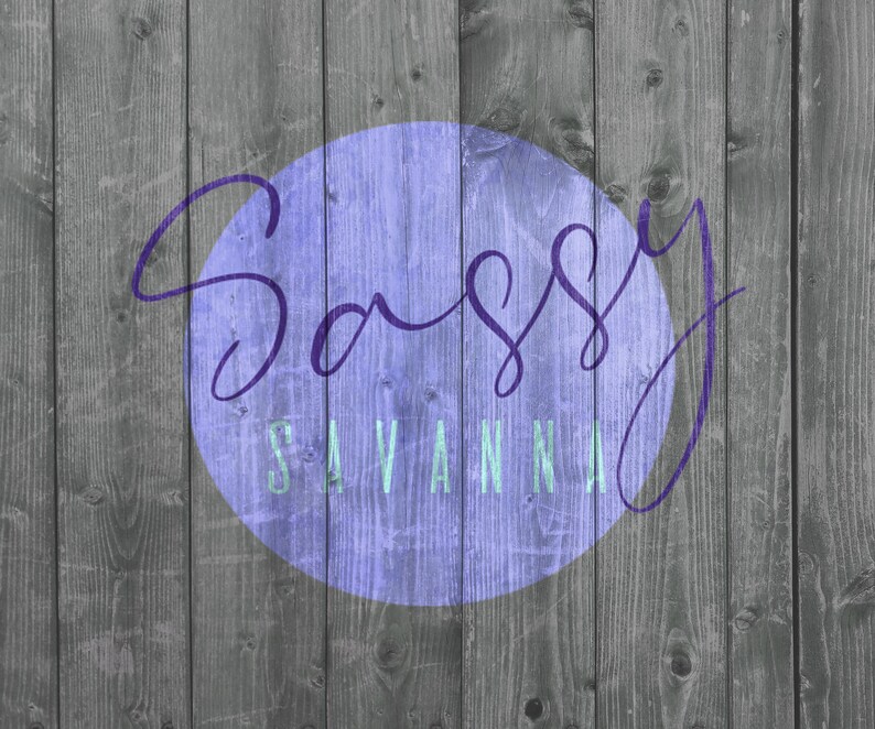 May include: A wooden background with vertical planks in shades of gray. A purple circle in the center contains the words "Sassy Savannah" in a cursive font and a sans-serif font.