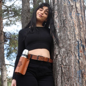 Model wearing Mandala Brown Leather Bottle Holder attached to her belt