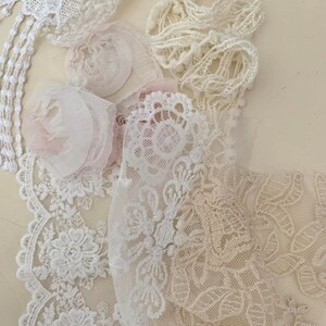 May include: Assortment of white and beige lace trims, including delicate floral patterns and scalloped edges. The lace is perfect for adding a touch of elegance to any project.