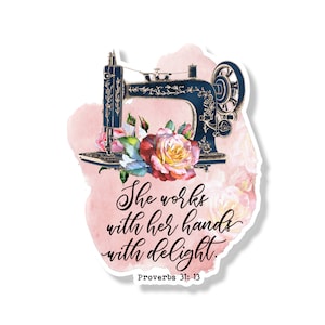 May include: A vintage-style sewing machine with floral accents on a pink watercolor background. The text "She works with her hands with delight. Proverbs 31:13" is written below the machine.