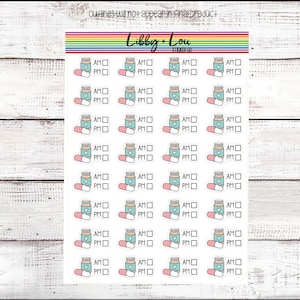 May include: A sheet of 24 sticker labels with a light blue pill bottle and a pink pill design. Each sticker has a check box with the words "AM" and "PM" next to it.