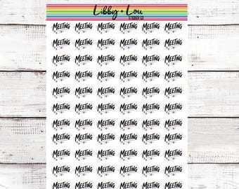 May include: A sticker sheet featuring a repeating pattern of the word MEETING in black script font, accented with small stars and hearts. The top of the sheet displays a rainbow-colored stripe and the text Libby + Lou Sticker Co.