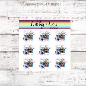 May include: Nine sticker sheets with a blue and brown camera design with flowers and the text "When life gets blurry adjust your focus". The sticker sheets are white with a rainbow border.