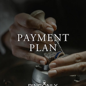 May include: A gold ring featuring a row of blue baguette-cut gemstones held in a metal setting. The text PAYMENT PLAN is centred in white, with the text RINGONLY and a small diamond icon positioned at the bottom of the image.