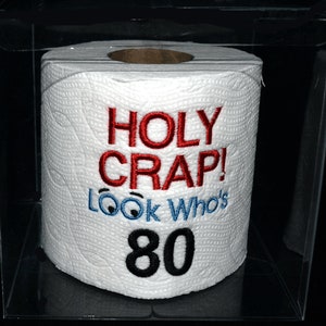 Holy Crap 80th birthday embroidered toilet paper in clear gift box. Perfect gag gift, table decoration, or party centerpiece decoration!