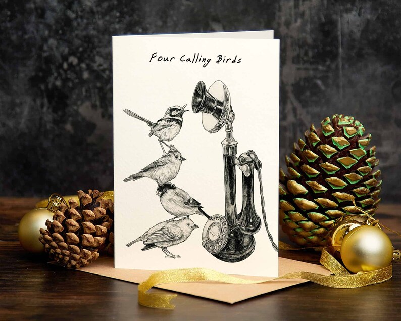 May include: A white card with black ink reads "Four Calling Birds". The card features a black and white illustration of four birds perched on an old-fashioned rotary phone.