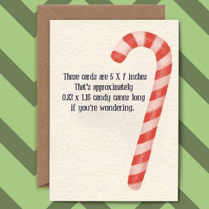 May include: A white card with a red and white candy cane illustration. The text on the card reads: "These cards are 5 X 7 inches. That's approximately 0.83 x 1.16 candy canes long if you're wondering."