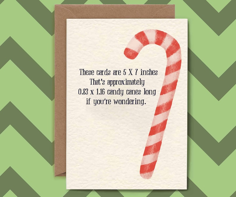 May include: A white card with a red and white candy cane illustration. The text on the card reads: "These cards are 5 X 7 inches. That's approximately 0.83 x 1.16 candy canes long if you're wondering."
