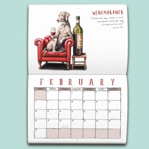 May include: A wall calendar page for February featuring a Weimaraner dog sitting in a red tufted armchair holding a wine glass next to a wine bottle on a stool. The text reads WINEMARANER and a quote by Groucho Marx about books and dogs.