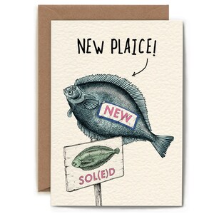May include: A humorous greeting card featuring a cartoon illustration of a fish labelled "NEW" and a sign that reads "SOL(E)D". The card has the text "NEW PLAICE!" at the top.