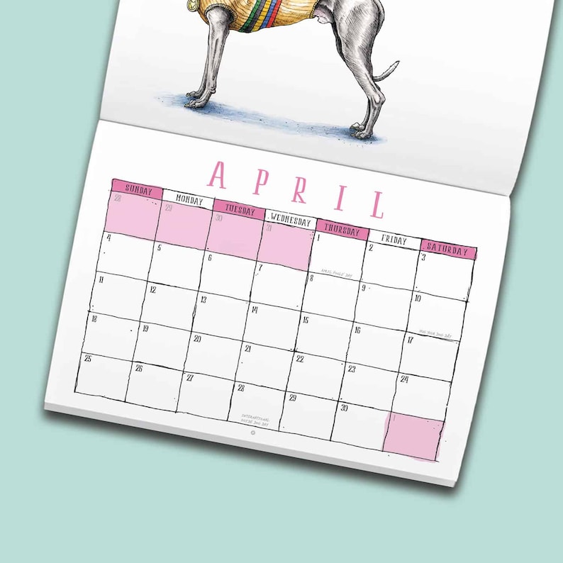 May include: A wall calendar page for the month of April featuring a hand-drawn illustration of a dog wearing a yellow sweater with colorful stripes. The calendar grid includes days of the week in pink headers and numbered dates in black ink.