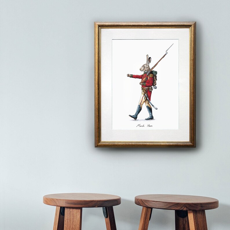 May include: A framed illustration of a rabbit dressed as a soldier, holding a rifle and marching forward. The illustration is titled "March Hare".