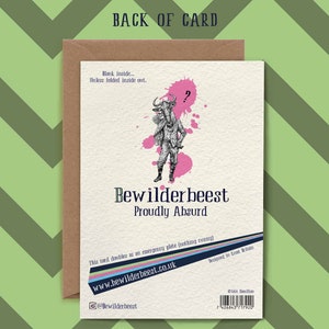 May include: A brown card with a pink and white illustration of a wildebeest wearing a hat and holding a cane. The text "Bewilderbeest Proudly Absurd" is printed on the card. The card also includes the website address "www.bewilderbeest.co.uk" and the social media handle "@Bewilderbeest".