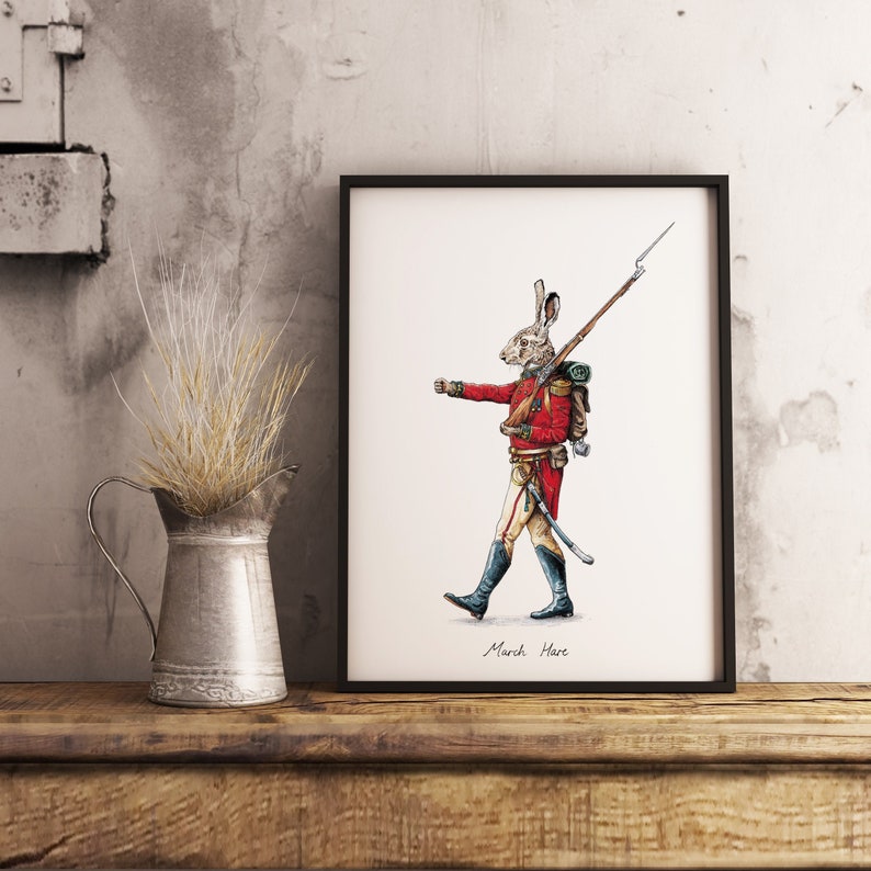 May include: A framed illustration of a rabbit dressed as a soldier, holding a rifle and wearing a red coat, a backpack, and a sword. The illustration is titled "March Hare".