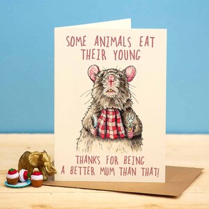 May include: A humorous greeting card featuring a cartoon rat holding a knife and fork, with the text "Some animals eat their young. Thanks for being a better mum than that!"