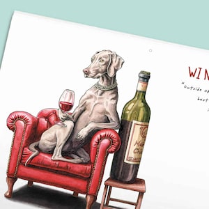 May include: A watercolor illustration of a Weimaraner dog wearing a pearl necklace, sitting in a red tufted armchair while holding a glass of red wine. Next to the chair is a bottle of red wine on a small wooden stool with the text WI N.