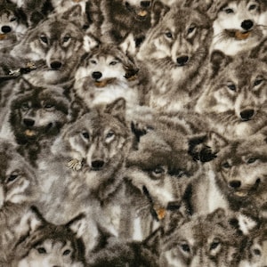May include: A close-up of a fabric featuring a repeating pattern of grey wolves. The wolves are facing different directions and have a soft, fuzzy texture.