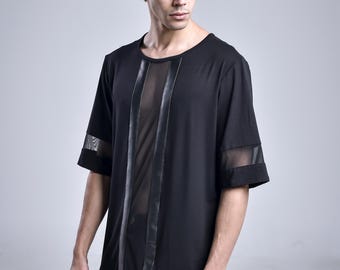 May include: A black short-sleeved shirt featuring a vertical sheer mesh panel down the center, flanked by solid black fabric strips. The garment includes horizontal mesh inserts on the sleeves and a round neckline, crafted with a long-line silhouette.