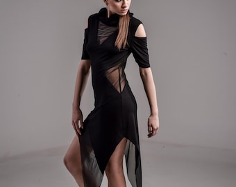 May include: A black knee-length dress with short sleeves, cold-shoulder cutouts, and a high neckline. The garment features sheer mesh panels at the chest and waist, with an asymmetrical hemline that extends into long, flowing sheer fabric panels.